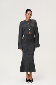 Woman wearing a Cessole cardigan and Cessole midi skirt in a gray textured knit, Adoore signature buttons, wide sleeves and cropped fit. thumbnail image
