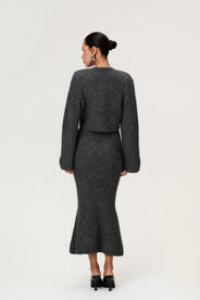 Woman wearing a Cessole cardigan and Cessole midi skirt in a gray textured knit, Adoore signature buttons, wide sleeves and cropped fit. thumbnail image