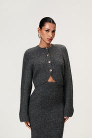 Woman wearing a Cessole cardigan in a gray textured knit, Adoore signature buttons, wide sleeves and cropped fit. thumbnail image