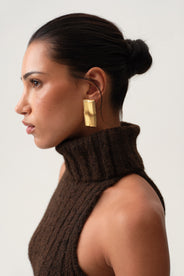 Modeel wearing Adoore sophisticated gold earring, timeless statement.  thumbnail image