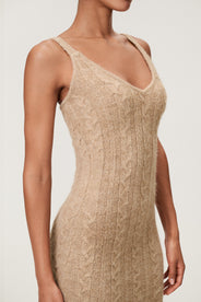 Woman wearing the Merano maxi dress in beige melange, a sleek, figure-flattering style with delicate singlet straps, a deep V-neckline, and an hourglass fit. thumbnail image
