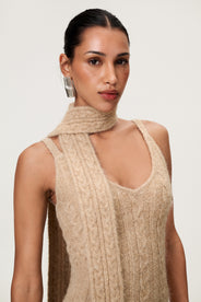 Woman wearing the Merano scarf in beige melange, styled with Merano dress in beige melange. The scarf is a lightweight knit with a soft texture, perfect for year-round layering. thumbnail image
