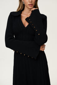 Black knitted dress in mini length and long sleeves. thumbnail image