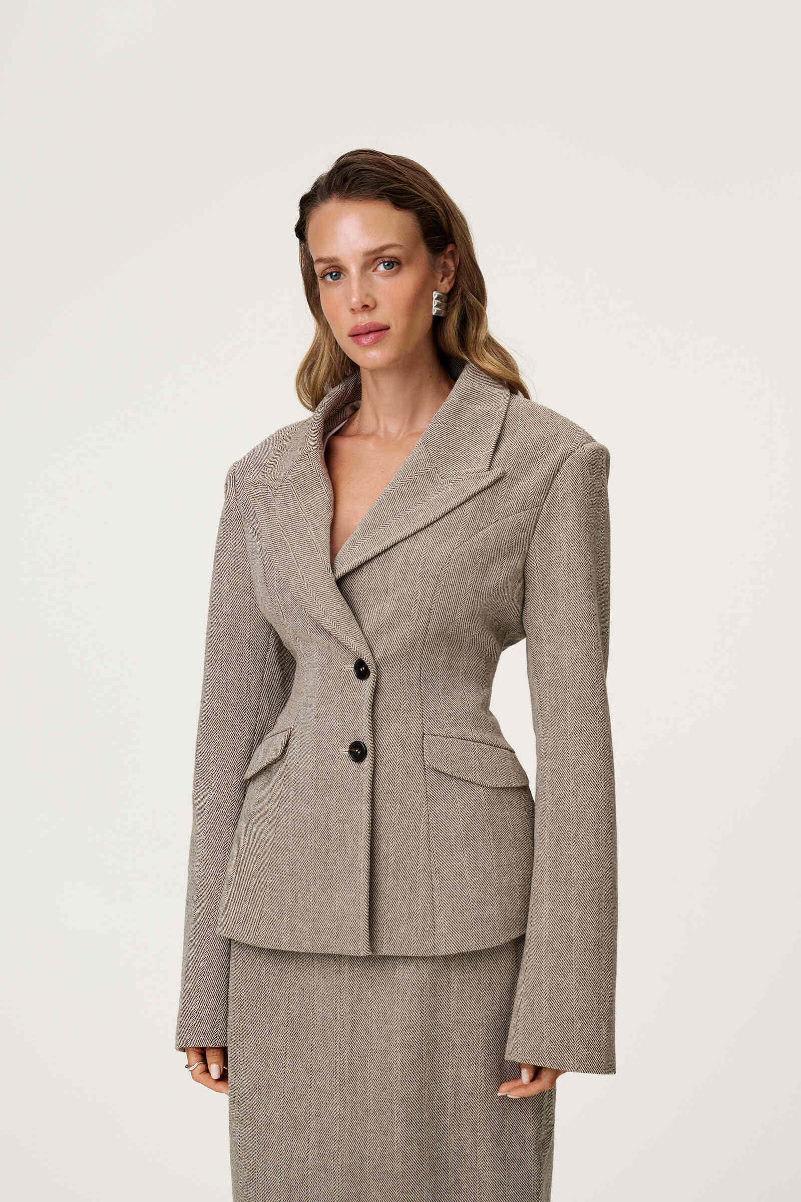 tweed blazer with buttons in the front and padded shoulders, fitted waist and long arms image