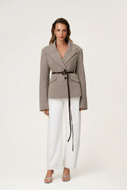 brown tweed blazer with buttons in the front and padded shoulders, fitted waist and long arms. fitted with white pants and brown suede belt in waist thumbnail image